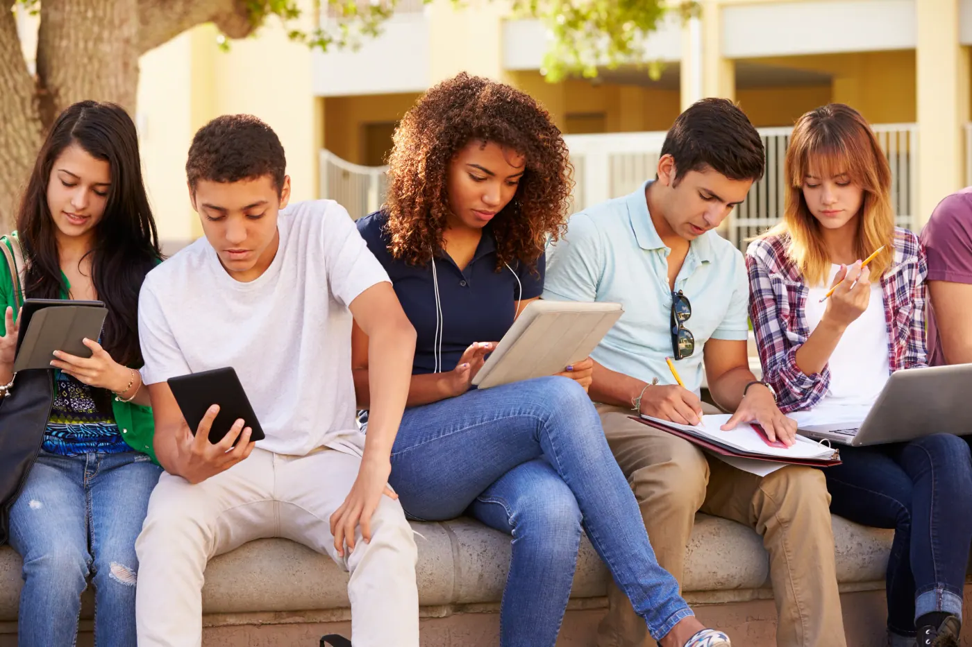 Students using tablets and notebooks